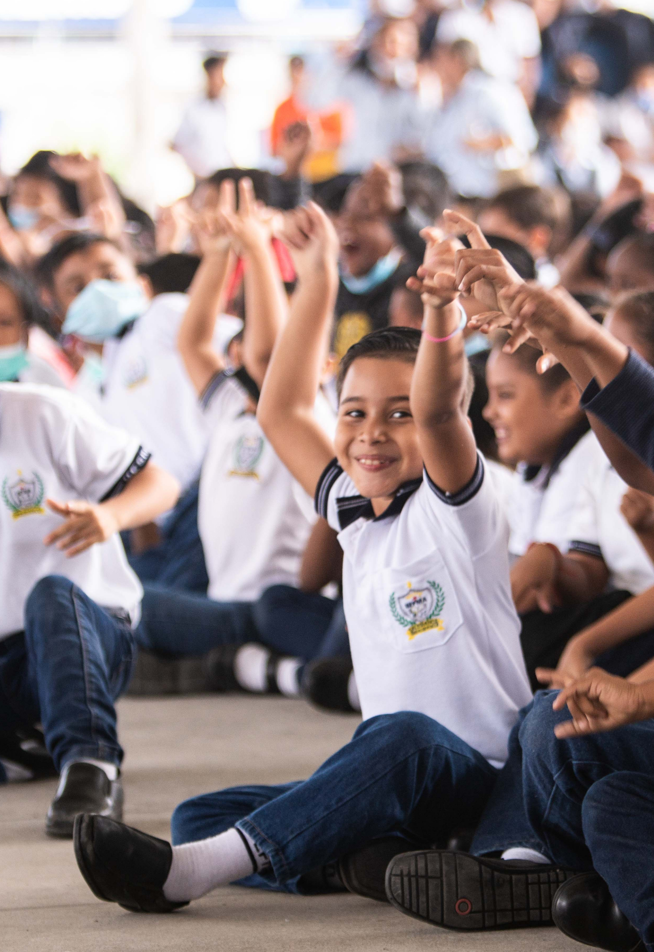 Group of kids raising hands
