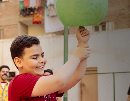 Child with spinning item and clown