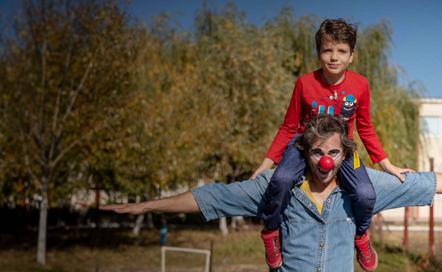 Performer with kid on shoulders