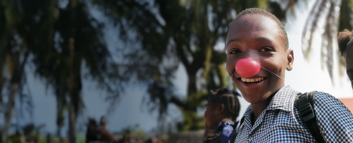 Smiling boy with a red clown nose