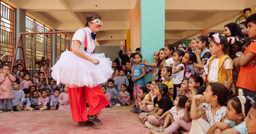 Clown on stage performing in a tutu